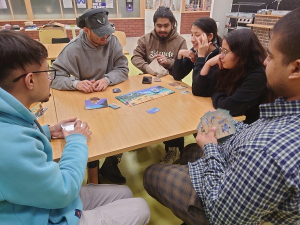Opiskelijat pelaavat Survivors of Hellapagos lautapeliä LAB-ammattikorkeakoulun Lahden kampuksella Kaptam Gamers lautapelikerhossa